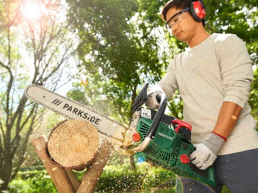 Petrol Chainsaw in use cutting a log
